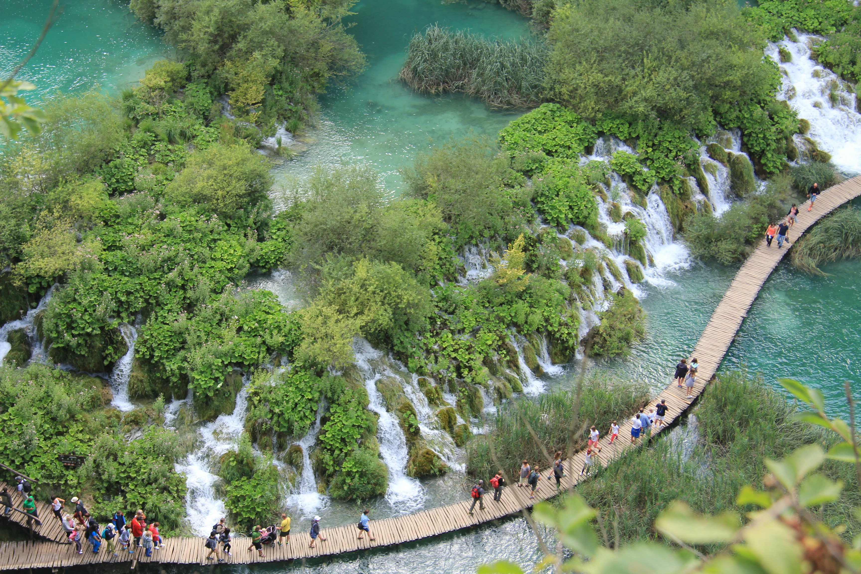 people walking on bridge over river during daytime