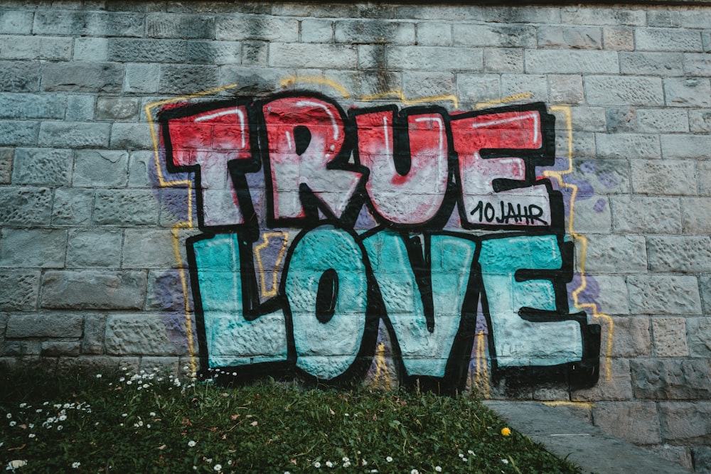 red blue and white graffiti on wall