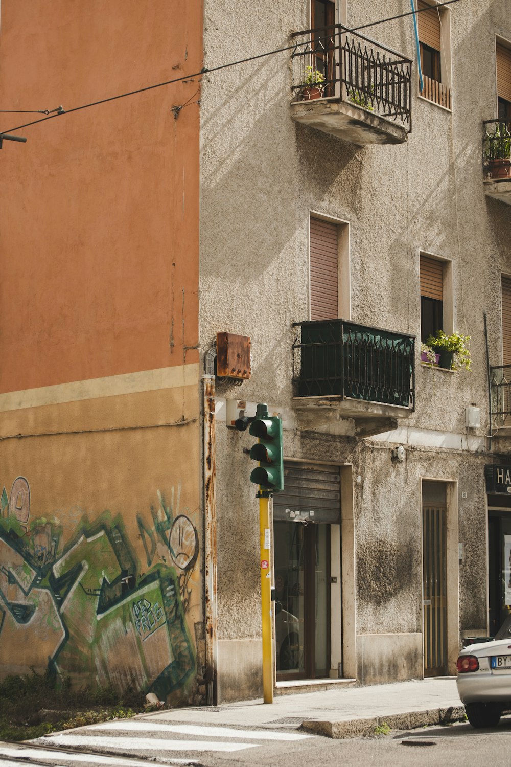 black and green graffiti on brown concrete building