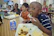 Happy children enjoying colorful, nutritious meals served at a lively school event.