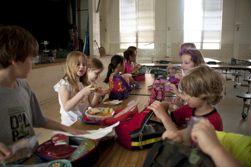 children sitting on chair eating