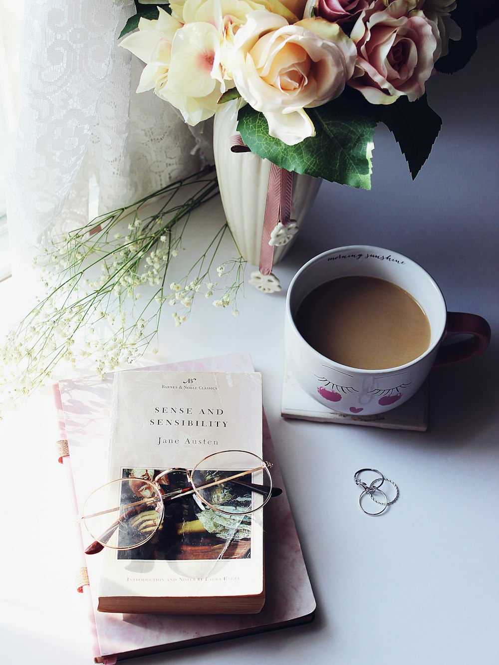 white ceramic mug beside white paper