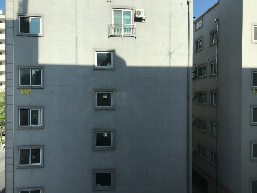 white concrete building with black windows