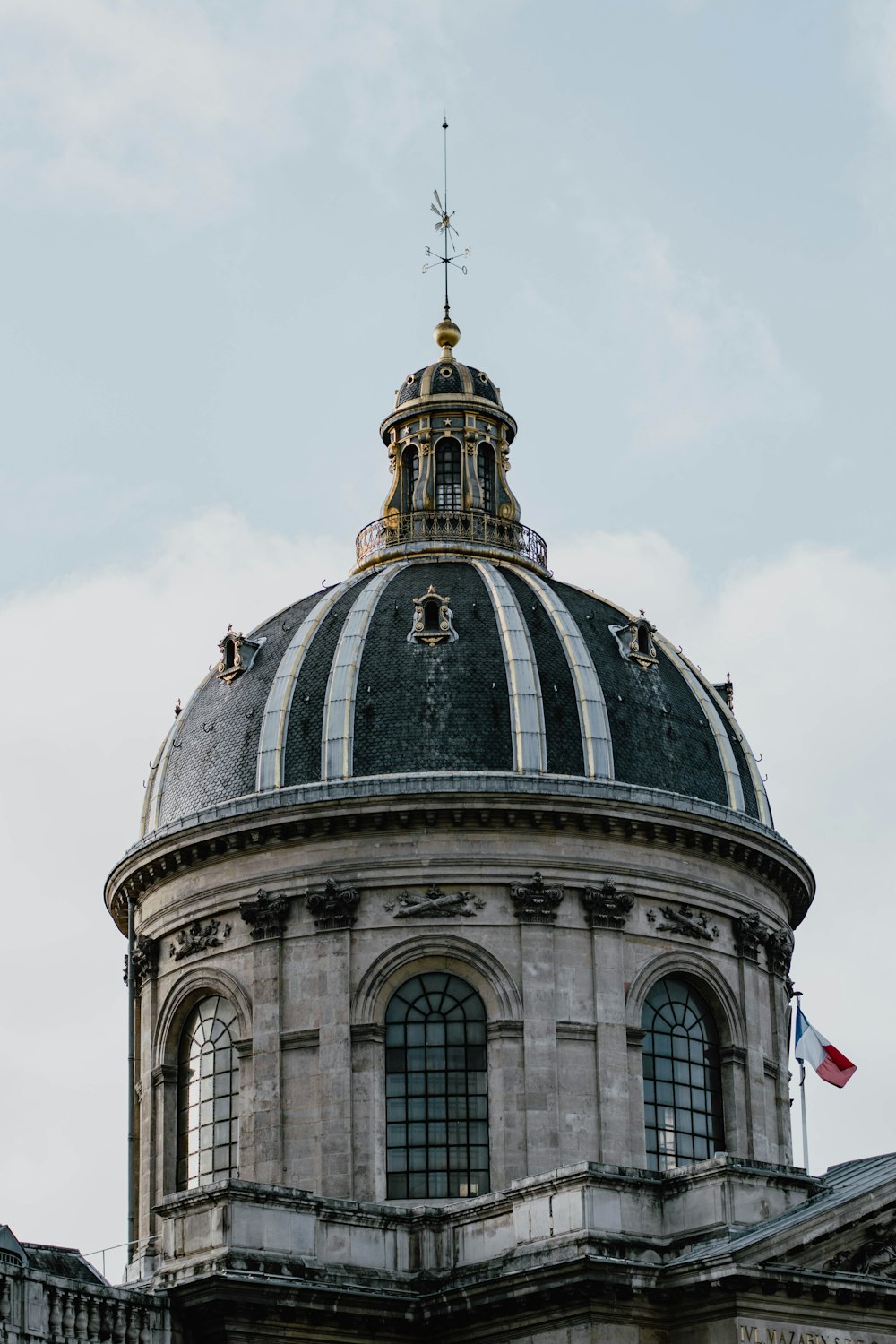 gray and white dome building under white clouds during daytime