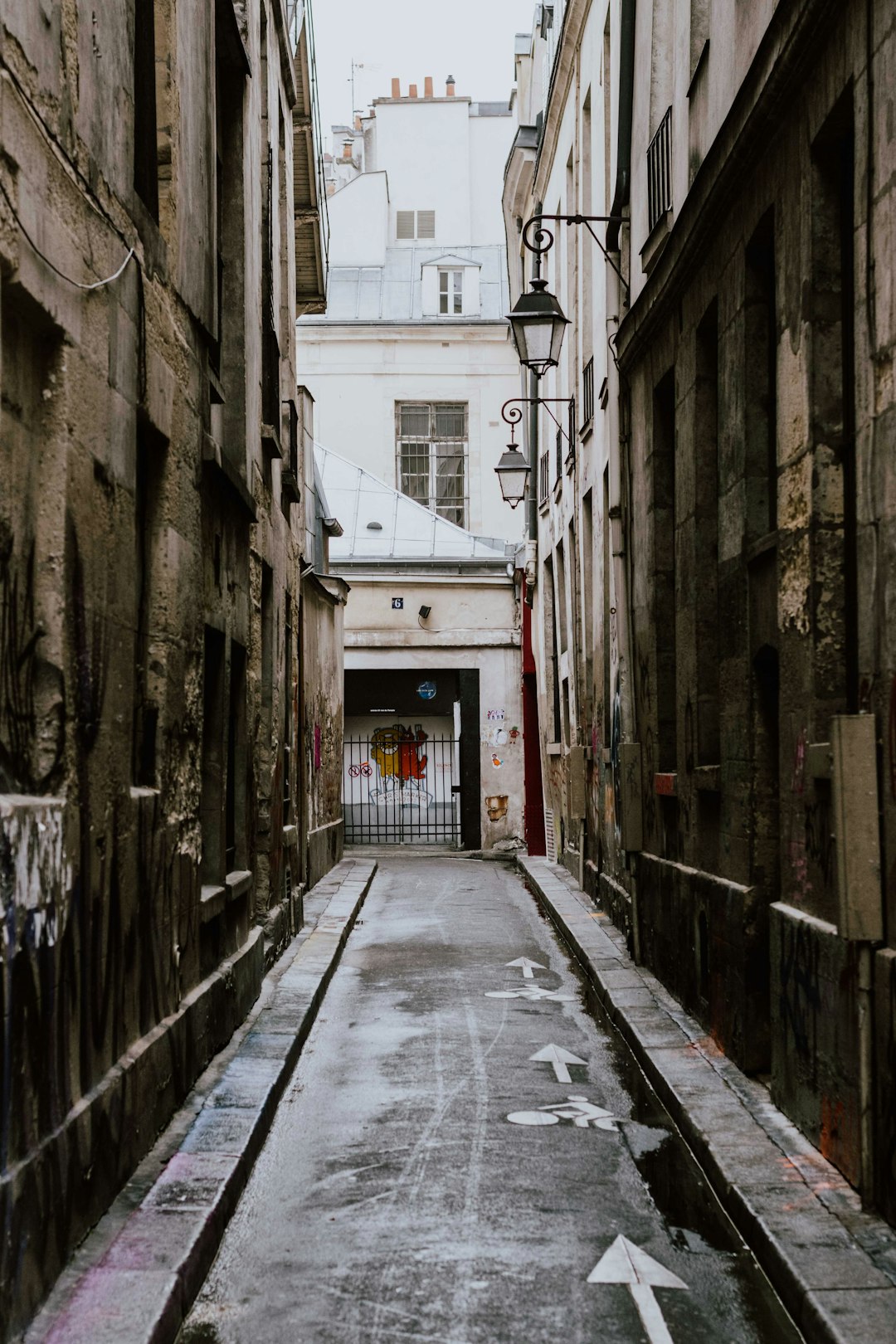 empty street between concrete buildings during daytime