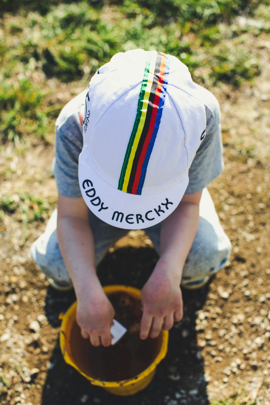 person in white t-shirt and multi color scarf