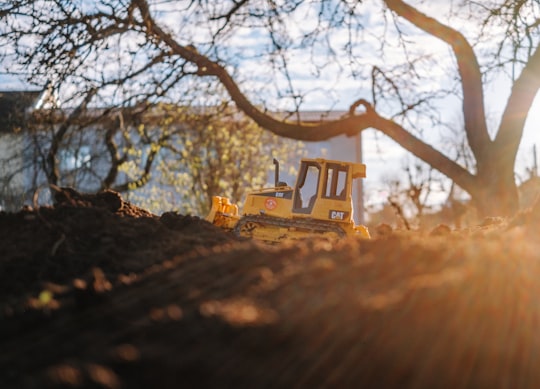 yellow and black heavy equipment near trees during daytime in Sigulda Latvia