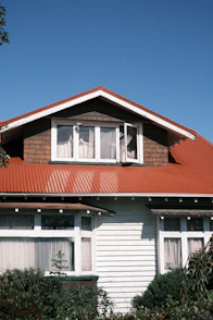 white and red wooden house under blue sky during daytime