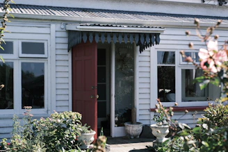 A warm, welcoming front door of a cozy home with a small garden, symbolizing comfort and care.