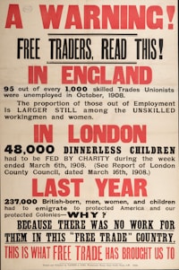 An old poster with bold red and black text addresses the economic issues in England. It describes unemployment among skilled trades unionists in 1908, the plight of dinnerless children in London who needed charity, and mass emigration due to lack of work, criticizing free trade policies.