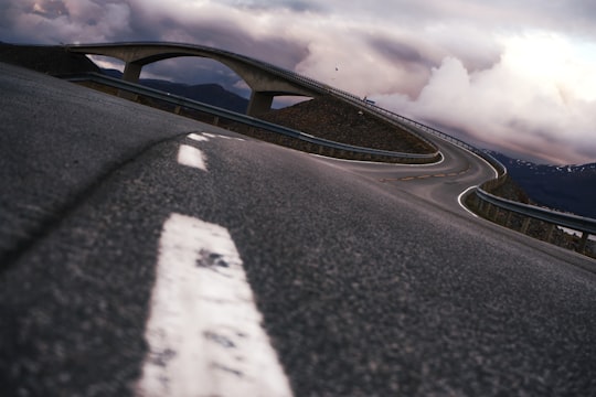 black and white road under cloudy sky in Atlantic Road Norway