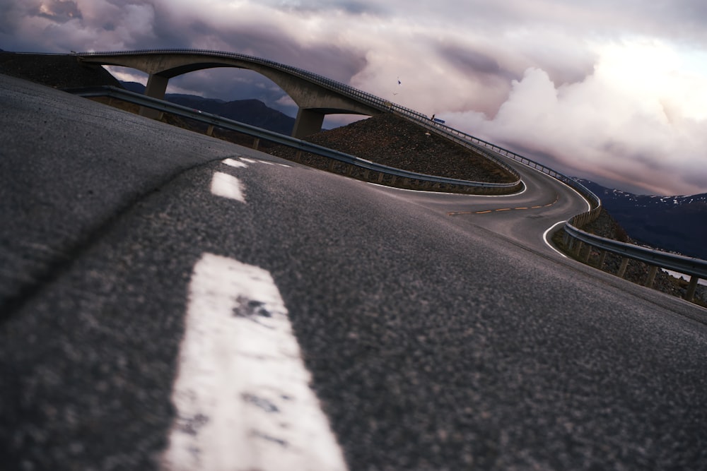 black and white road under cloudy sky