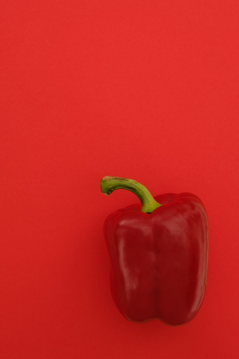 red bell pepper on red surface