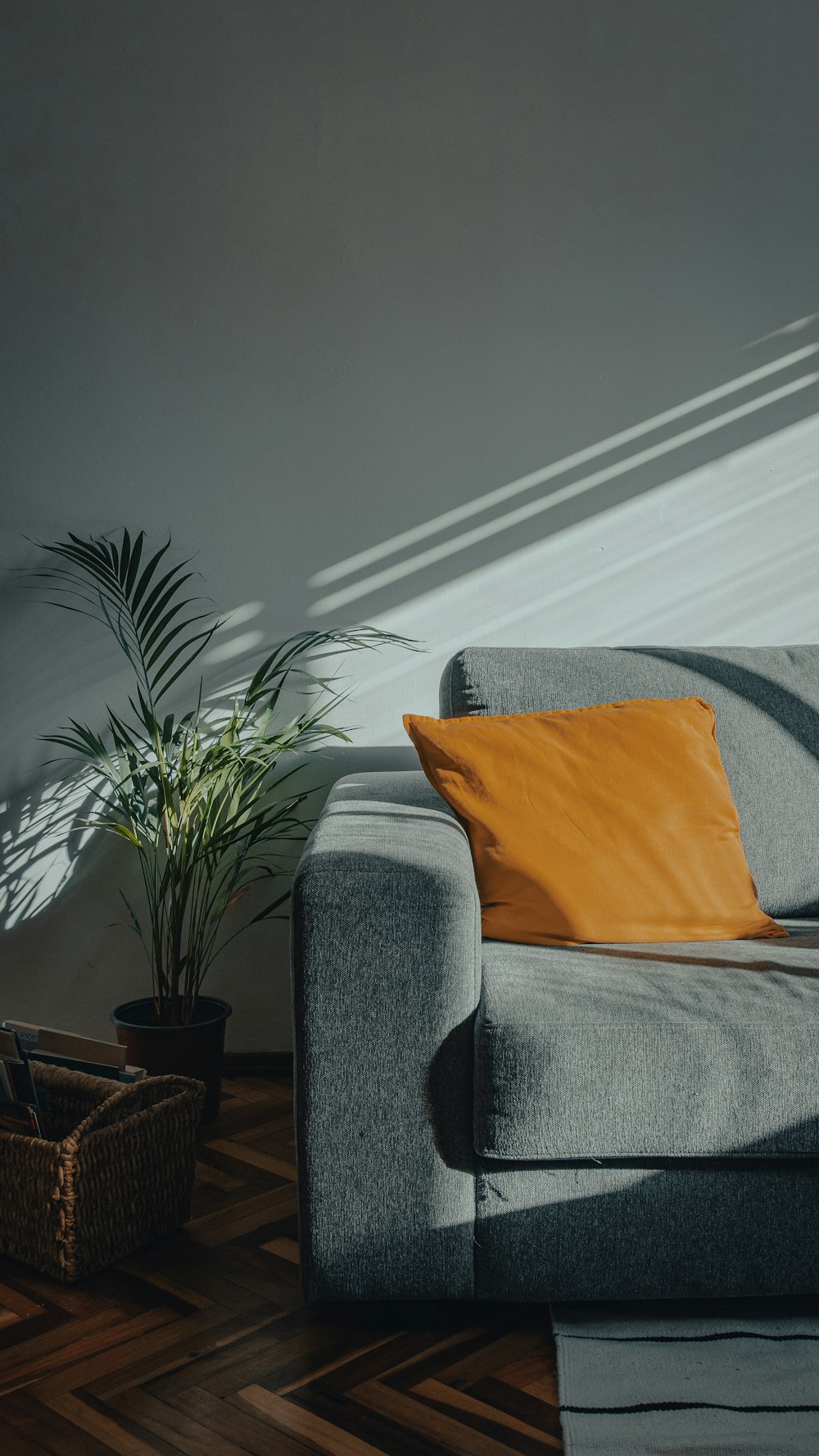 orange throw pillow on gray couch