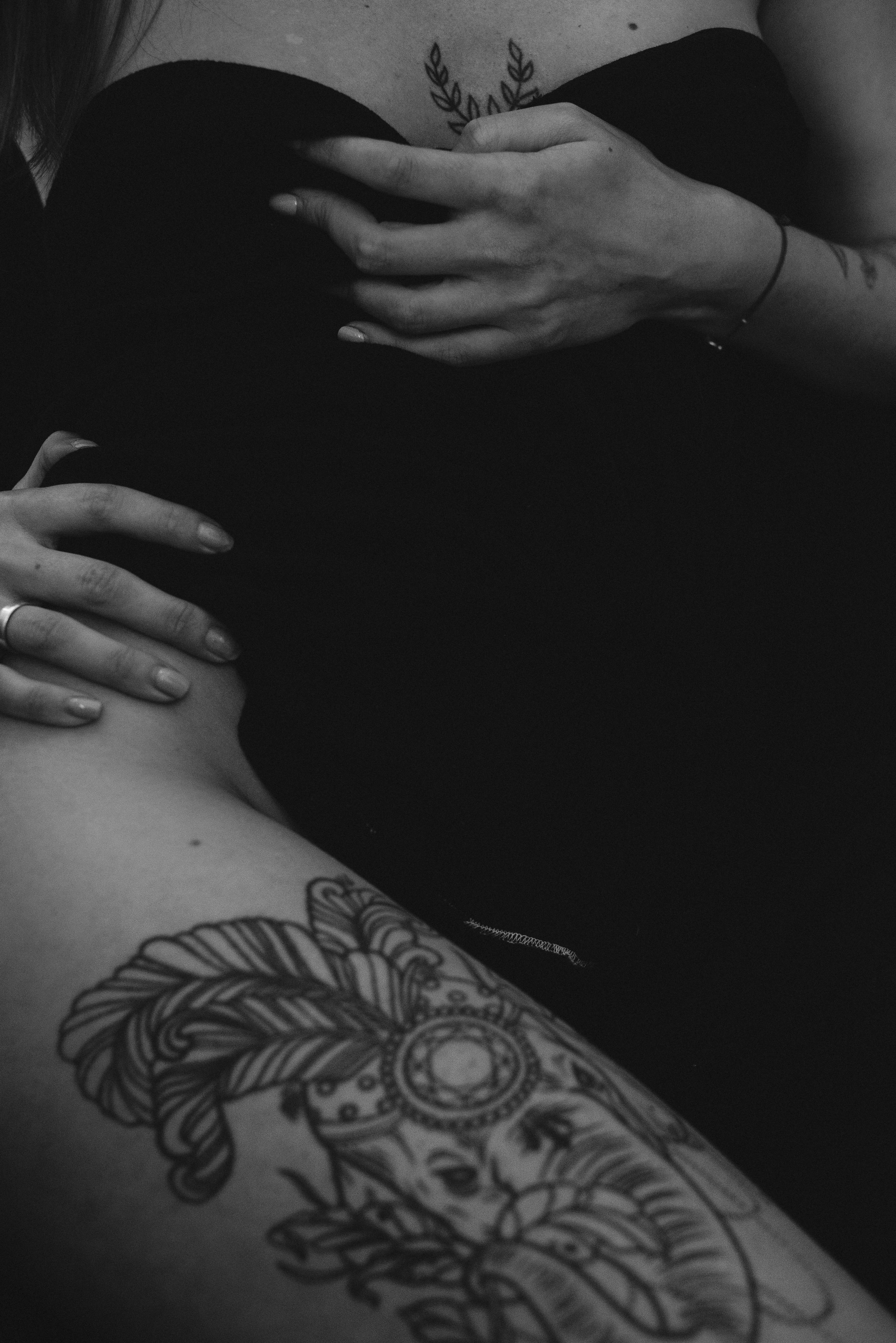 grayscale photo of person with tattoo on right hand