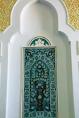 Handcrafted stucco wall panel with intricate patterns in warm beige and gold hues.