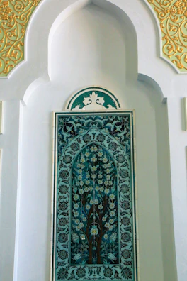 Handcrafted stucco wall panel with intricate patterns in warm beige and gold hues.