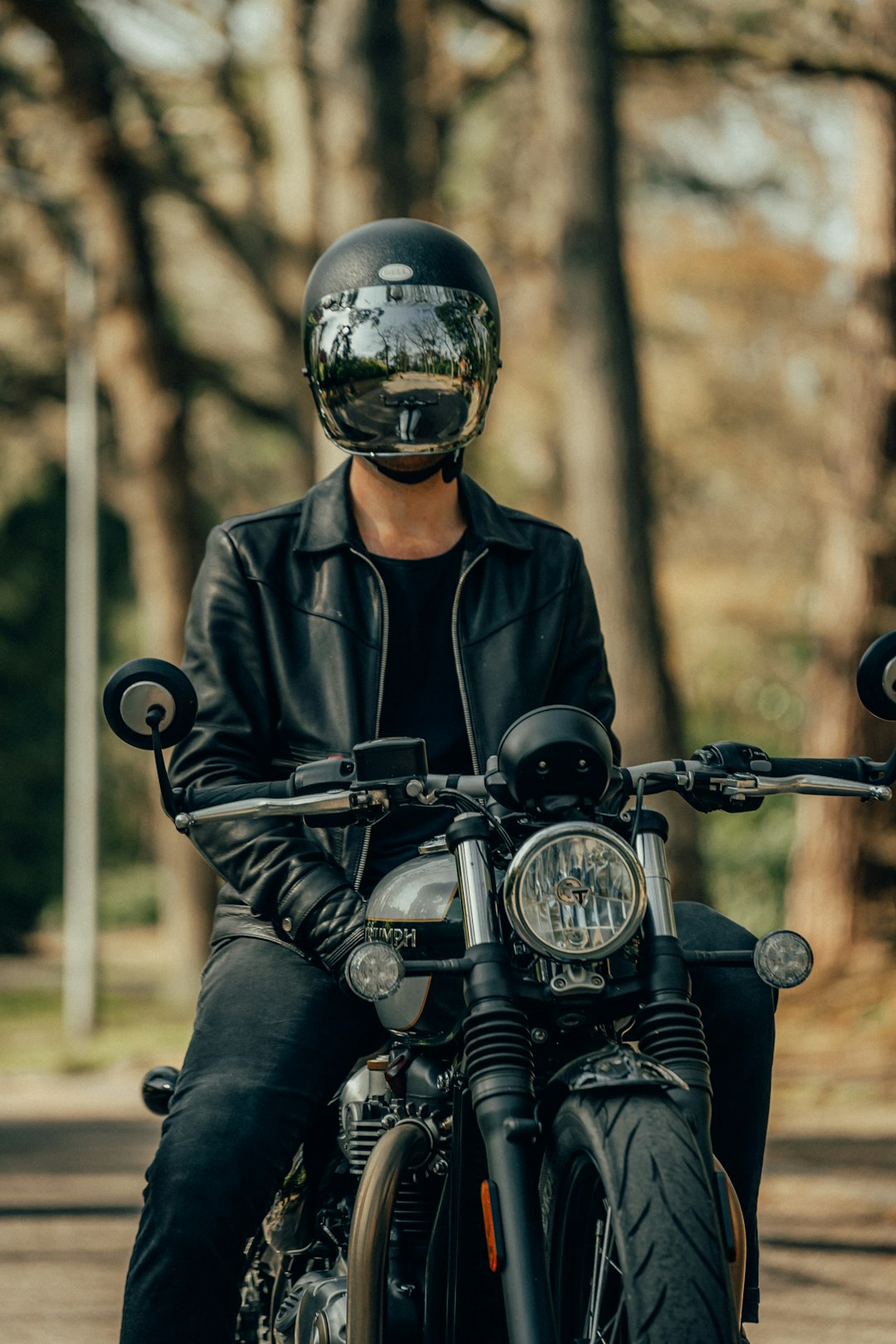 man in black leather jacket riding motorcycle