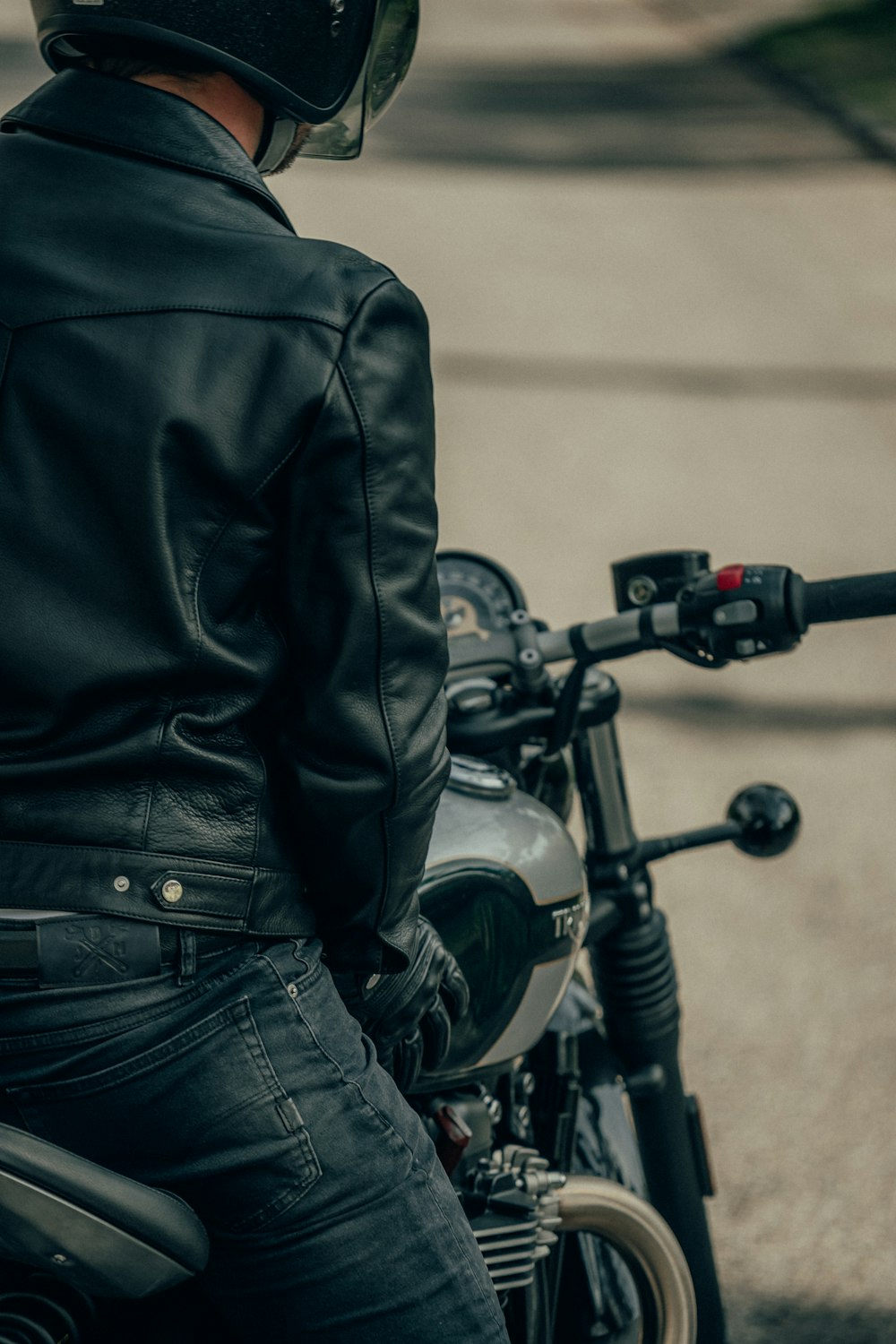black motorcycle with black leather jacket
