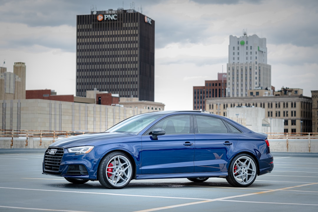Audi S3 on rooftop of a parking garage in a city.