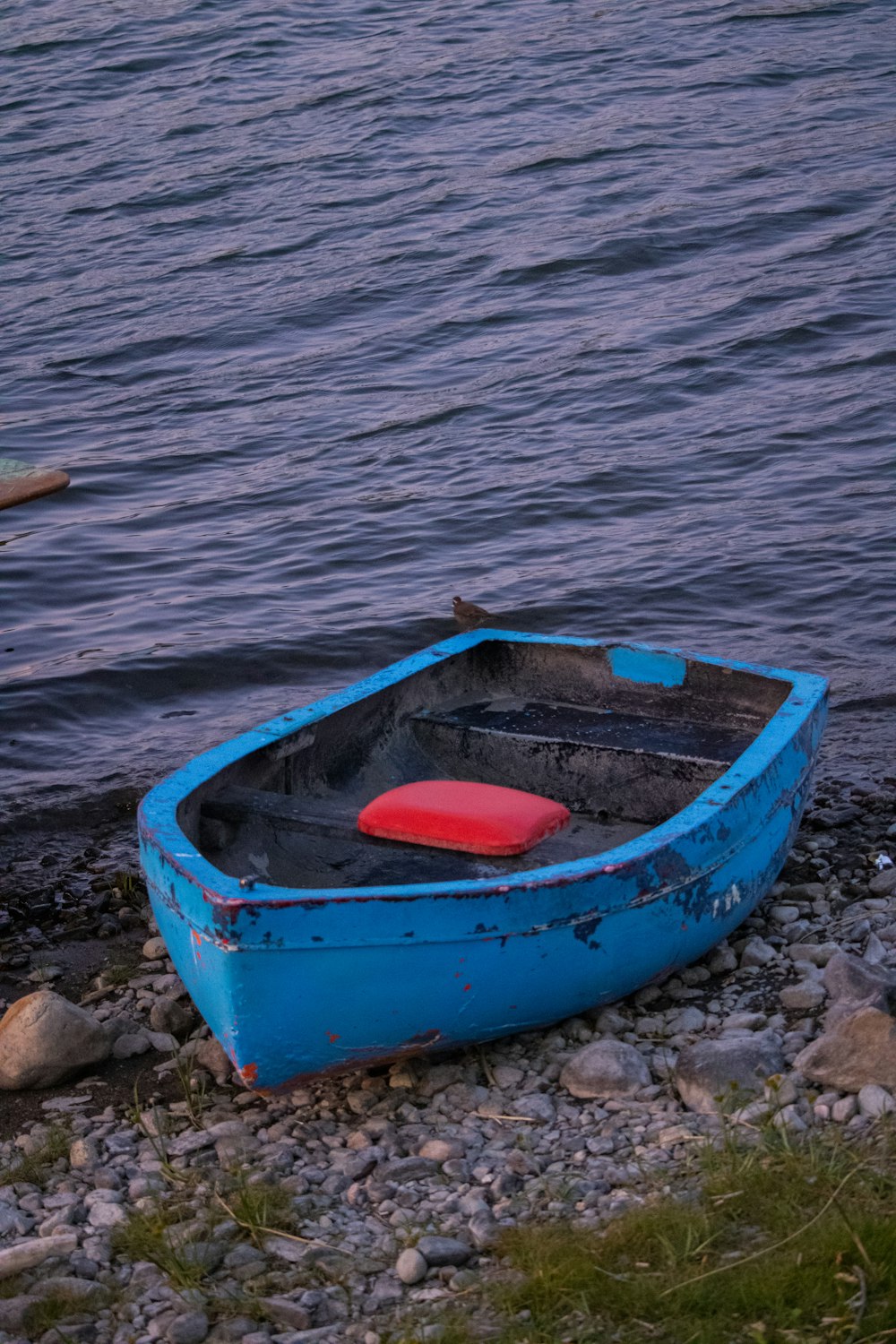 red and blue boat on blue sea water during daytime
