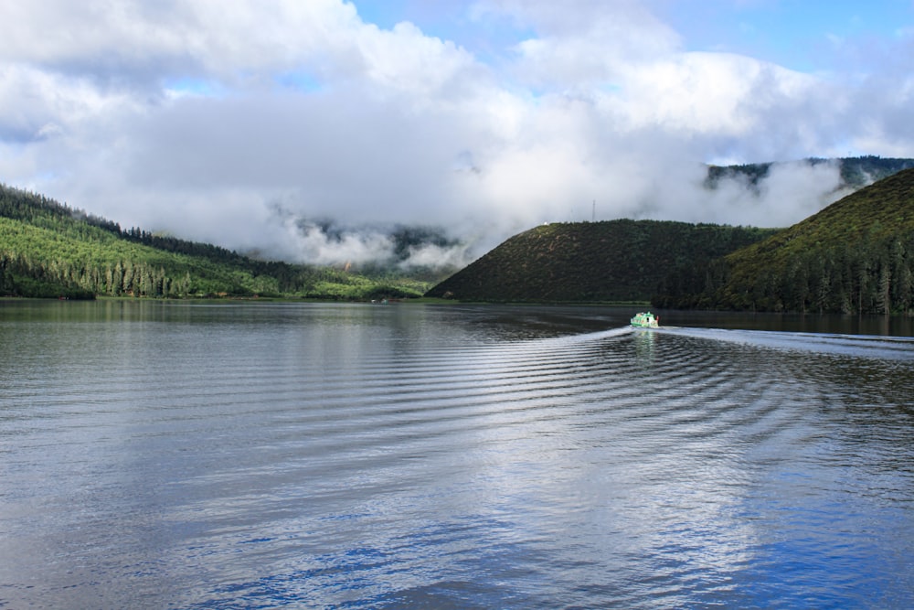 person in white shirt riding white boat on river during daytime