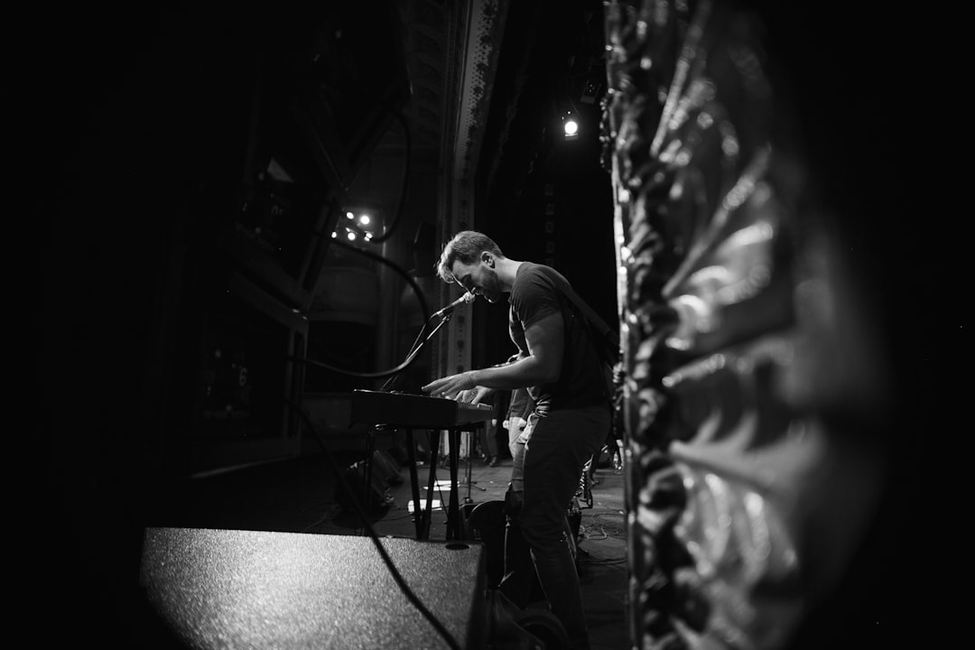 man in black t-shirt playing piano