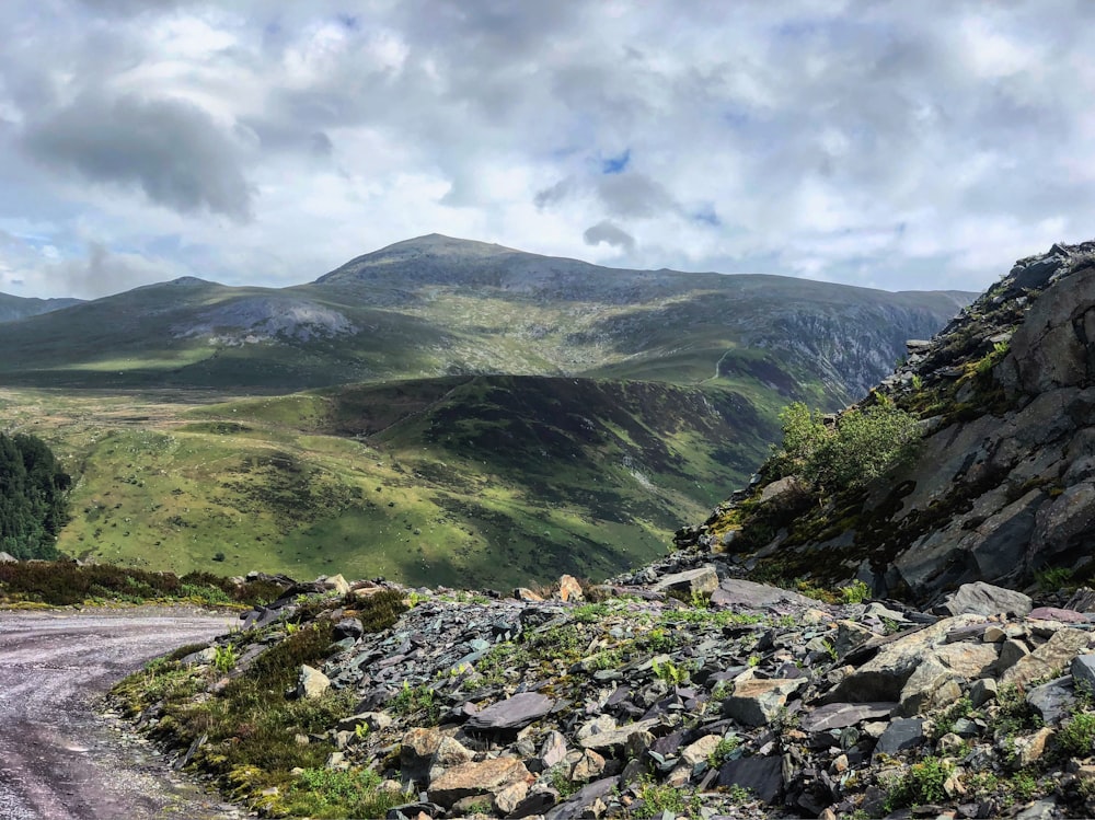 green mountains under white clouds and blue sky during daytime