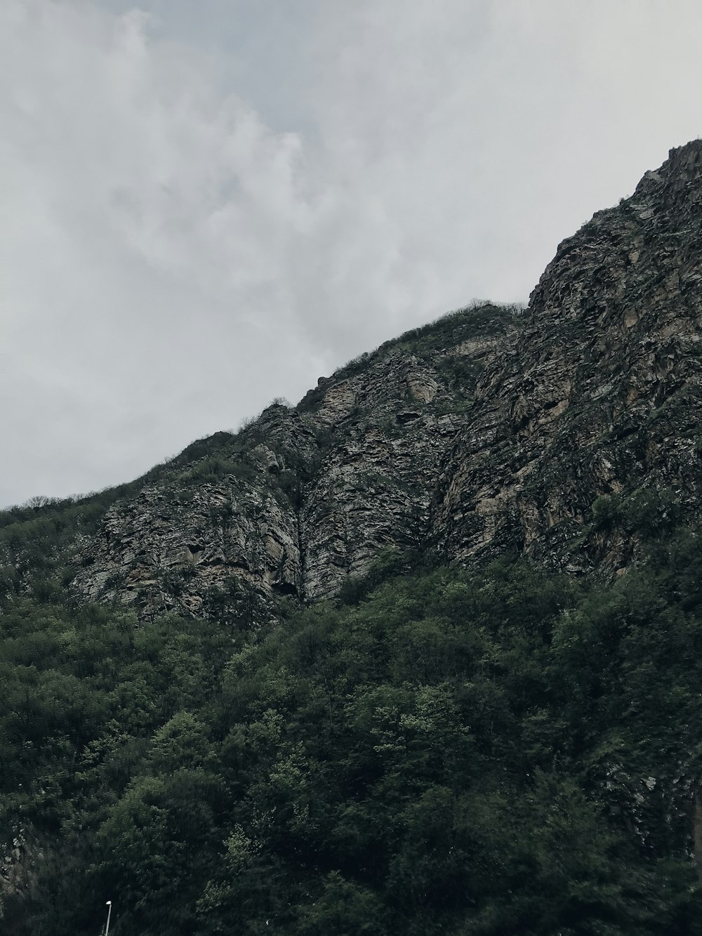 green and brown mountain under white clouds during daytime