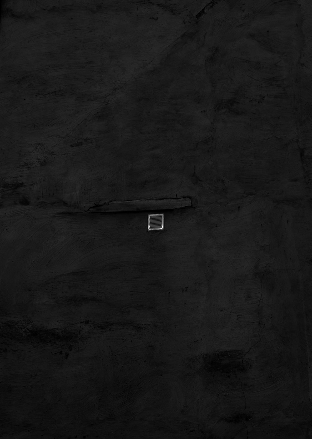 white light bulb on gray concrete wall