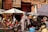 A joyful traveler enjoying a colorful market scene in Morocco.