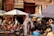 A joyful traveler enjoying a colorful market scene in Morocco.