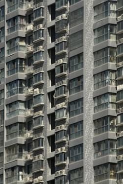 Modern condo building in downtown Montreal with balconies and city view.