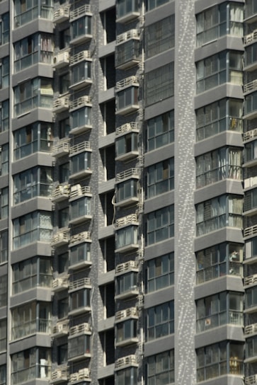 Modern condo building in downtown Montreal with balconies and city view.