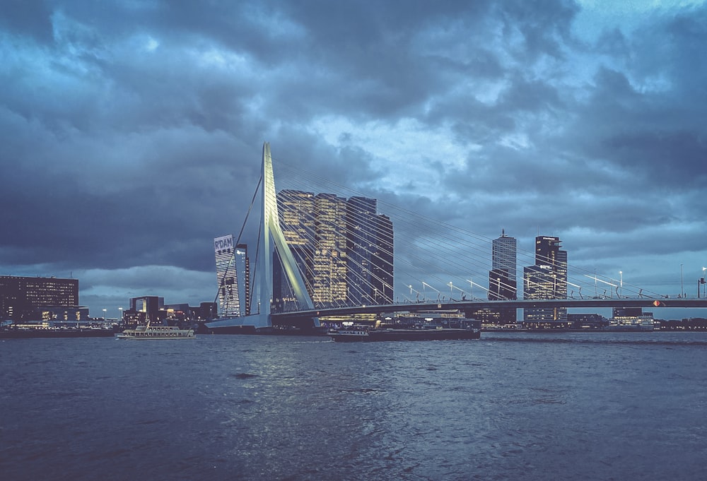 city skyline across body of water under cloudy sky during daytime