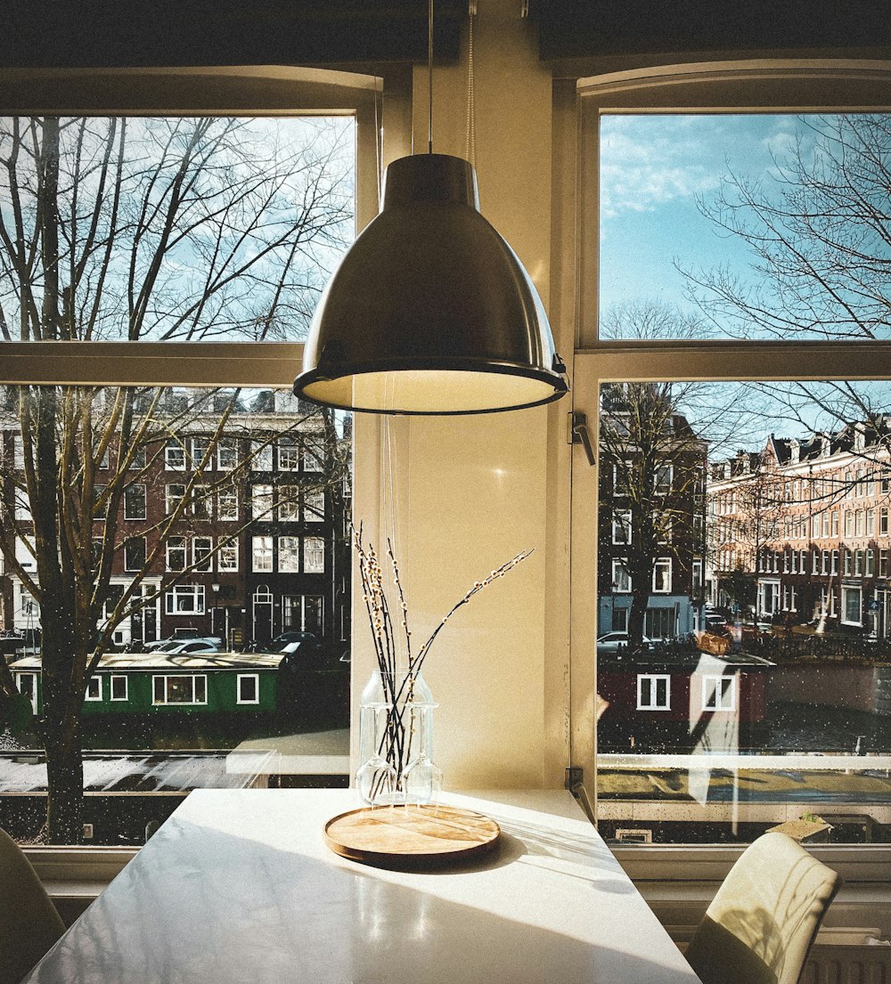 clear glass pendant lamp on white table