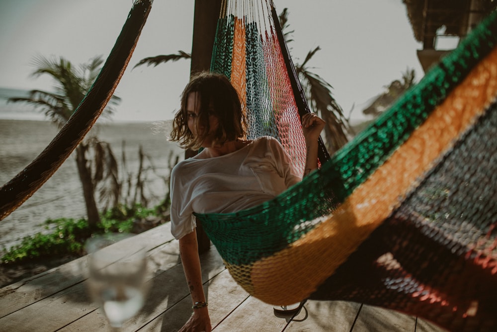 woman in white shirt sitting on hammock