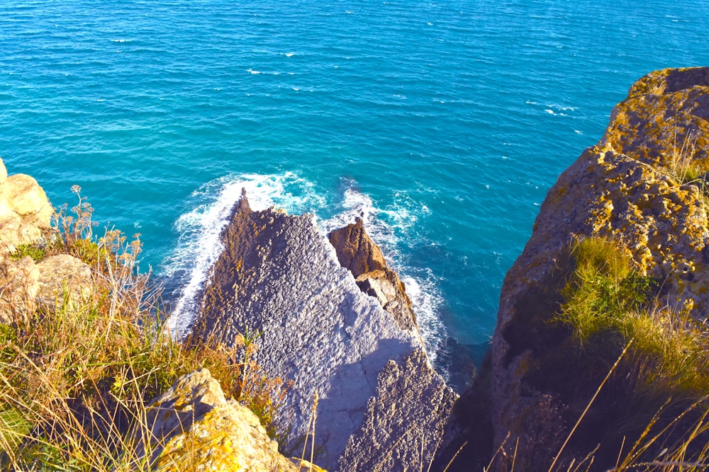 aerial view of rocky mountain beside sea during daytime