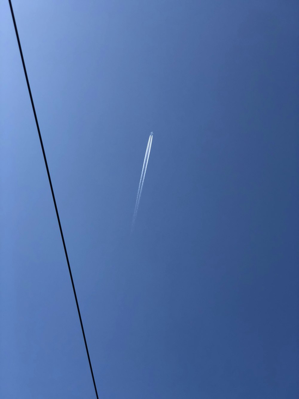 black coated wire under blue sky