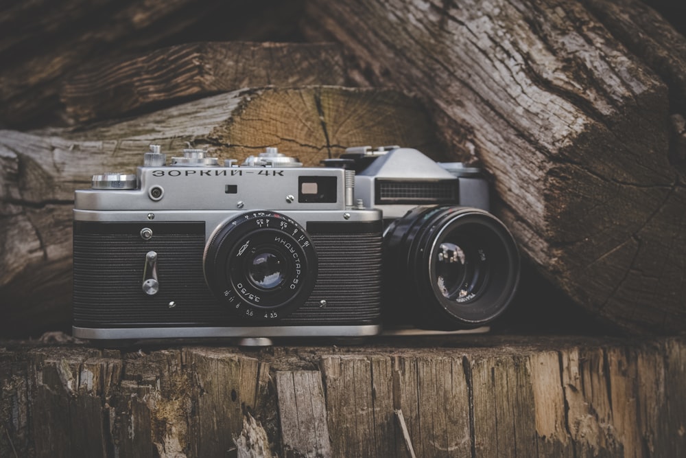 black and silver camera on brown wooden table