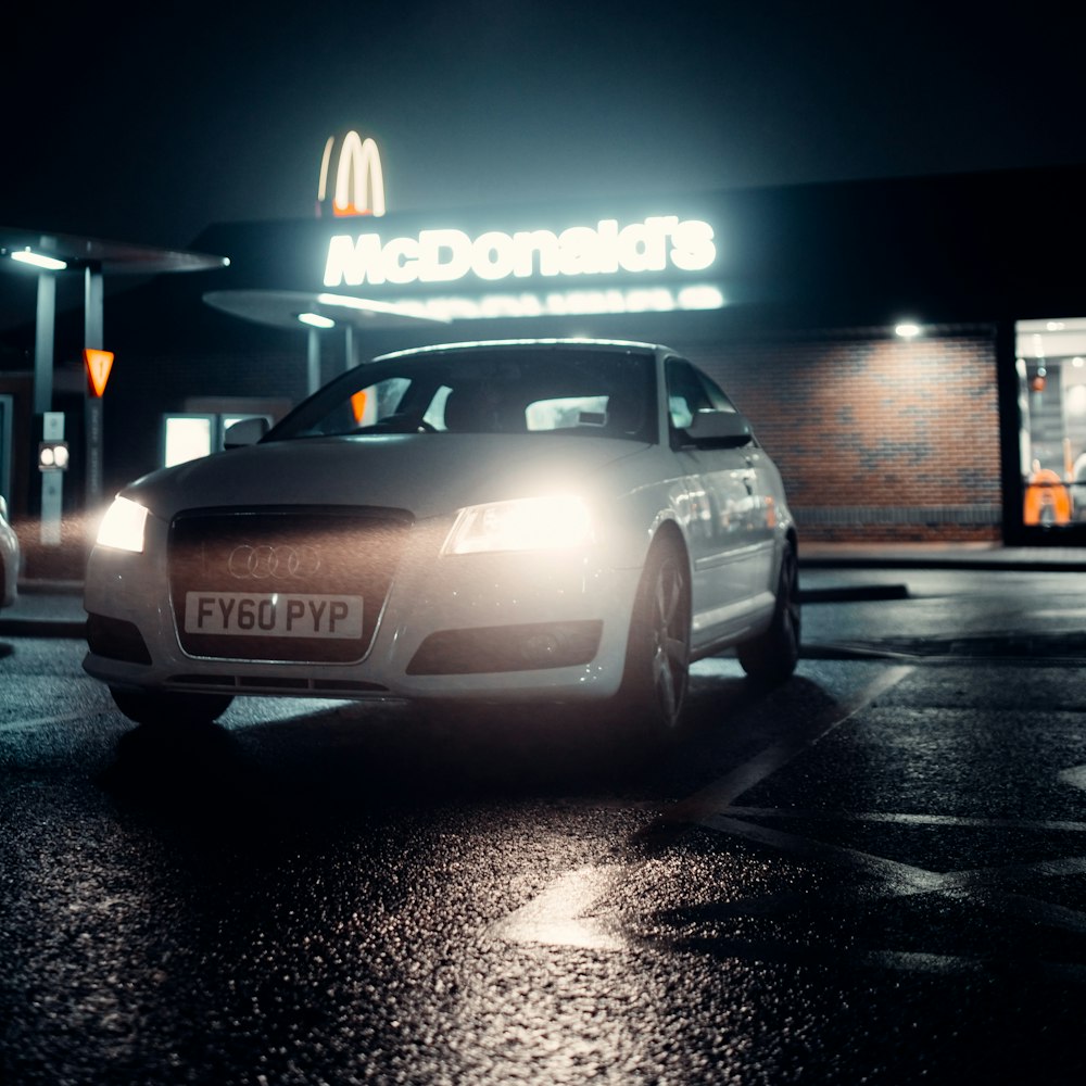 silver bmw m 3 parked on parking lot during night time