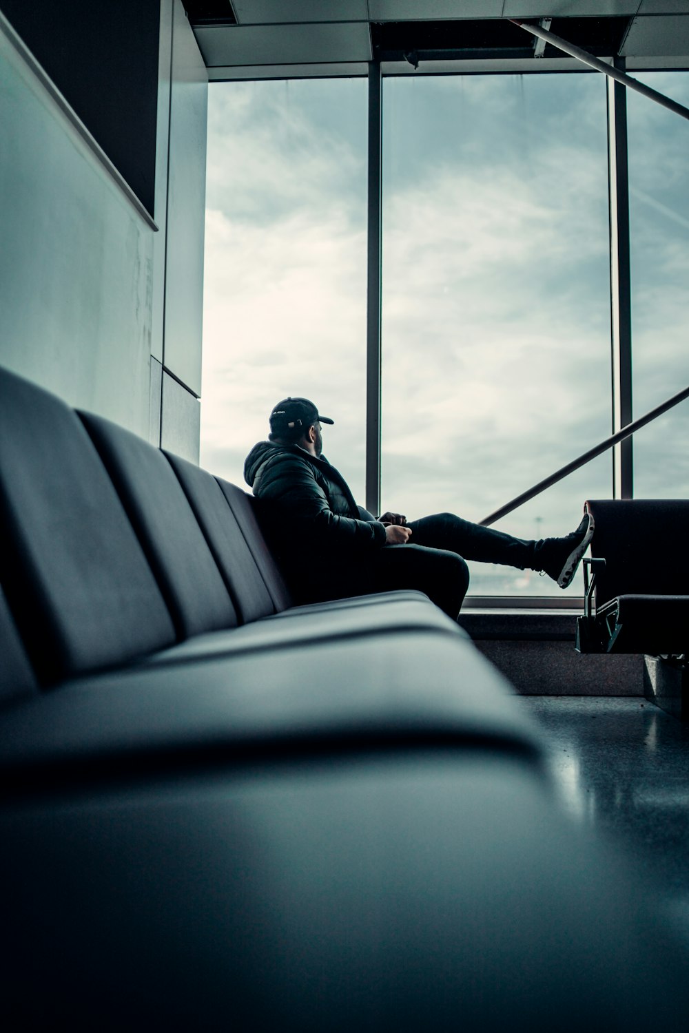 man in black jacket sitting on train seat