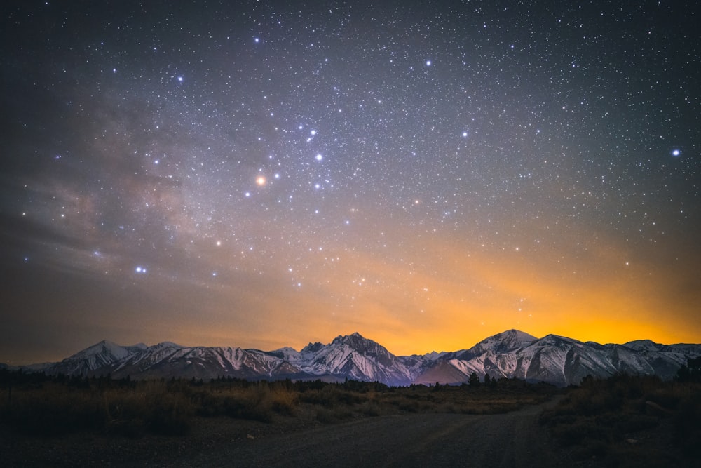 snow covered mountain under starry night