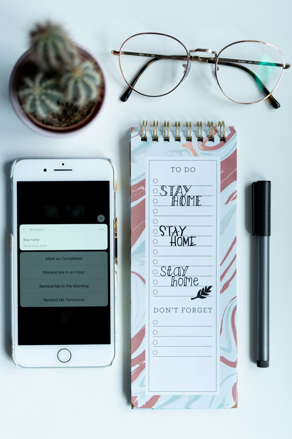 silver iphone 6 beside white and red pen