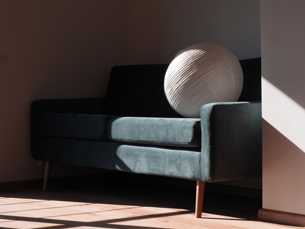 gray padded brown wooden framed armchair