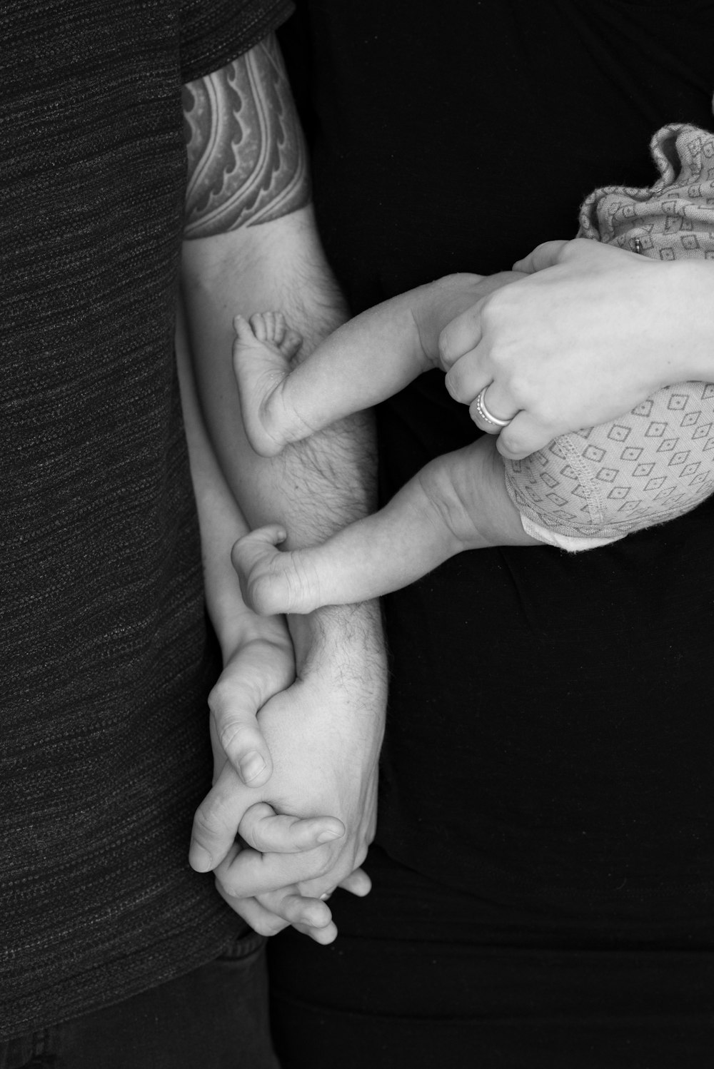 grayscale photo of couple holding hands