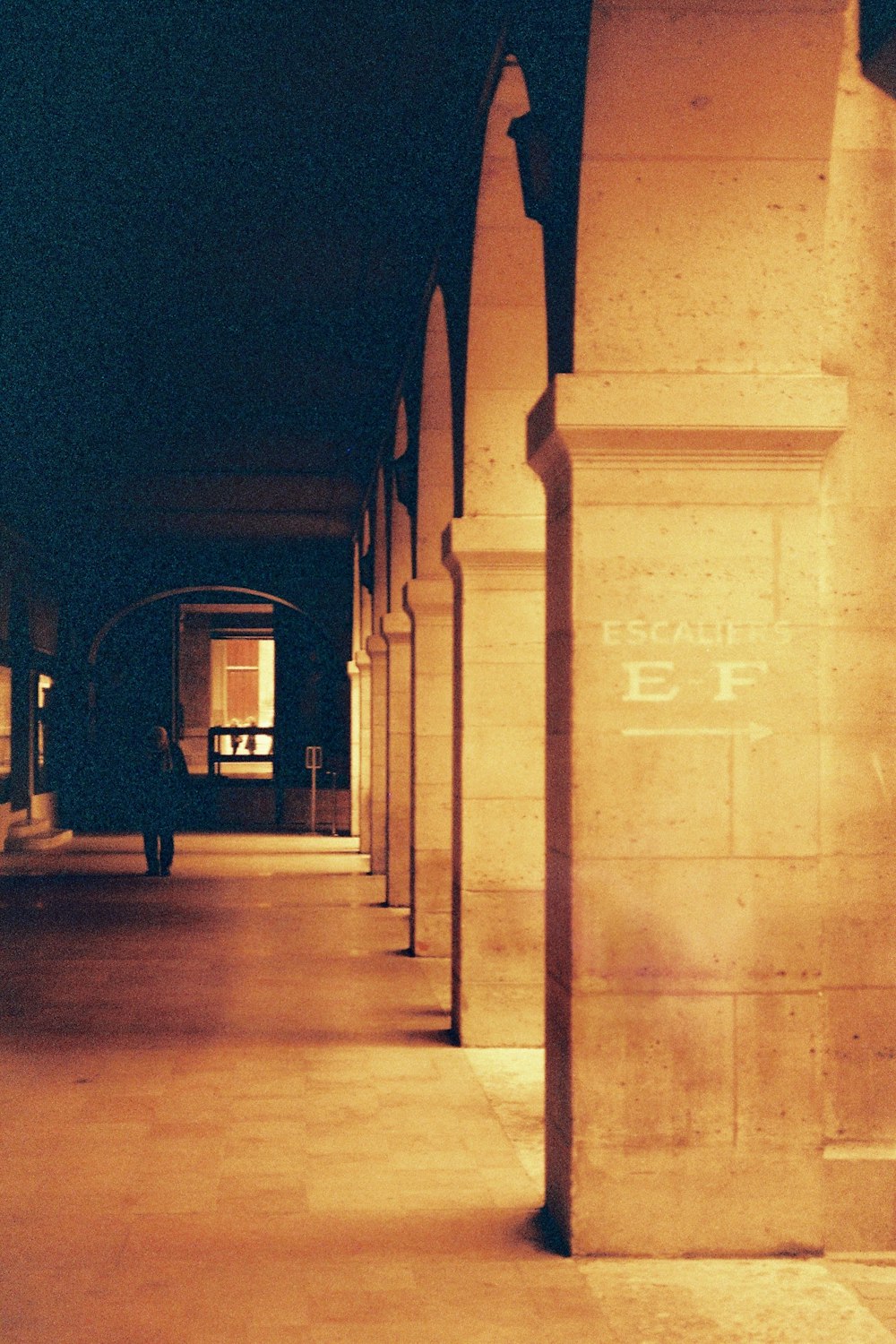 people walking on sidewalk during night time