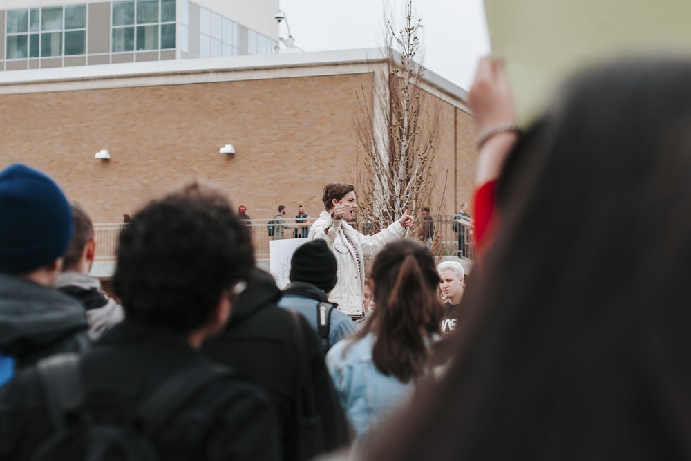 people standing near brown building during daytime