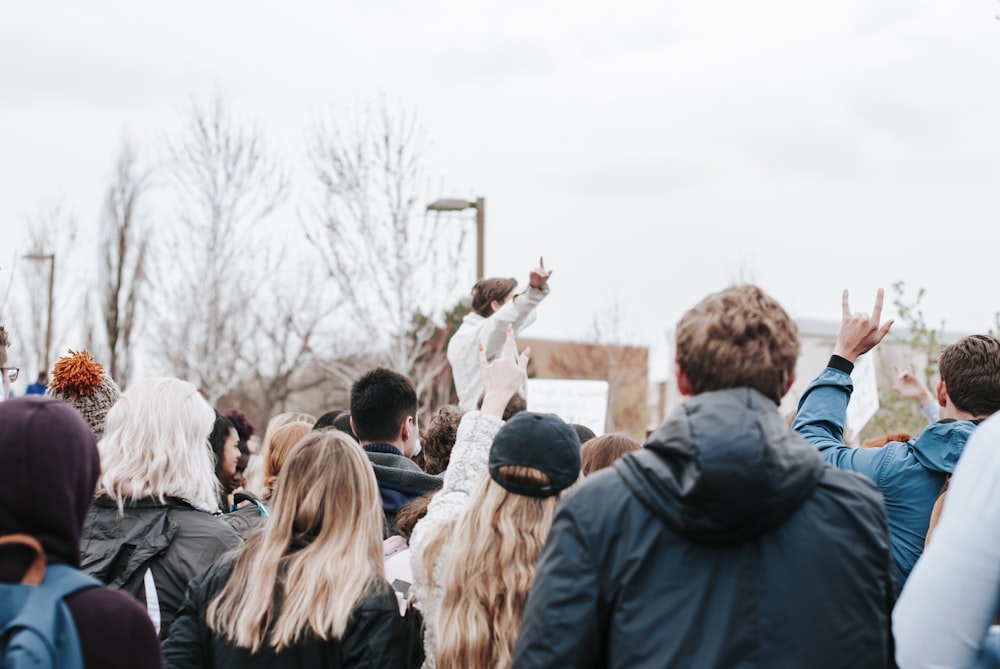 people standing on road during daytime