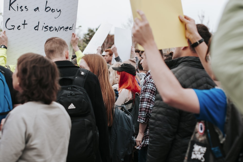 people standing and holding white printer paper